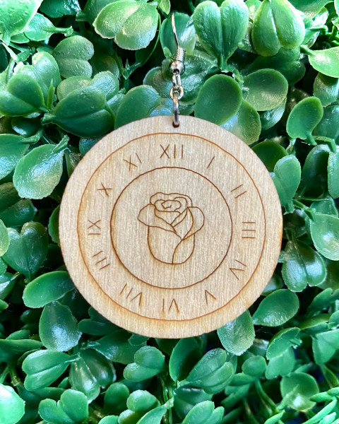 Laser cut baltic birch plywood with a rose in the center of a clock