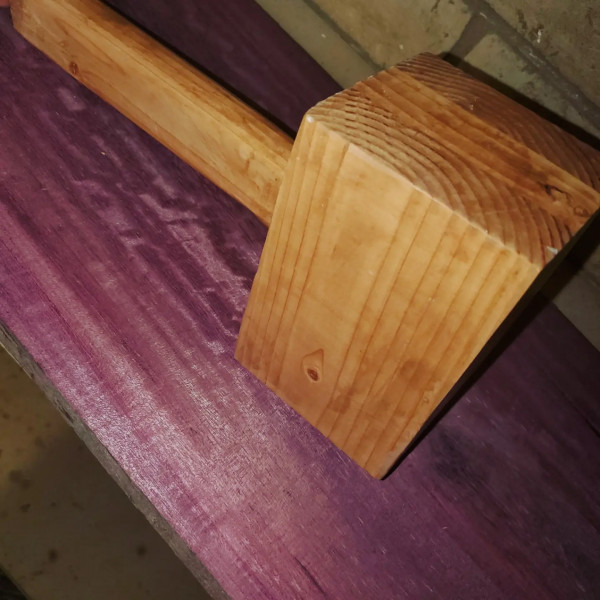 Wooden mallet made from repurposed wood with a dye finish and sealant coating curing